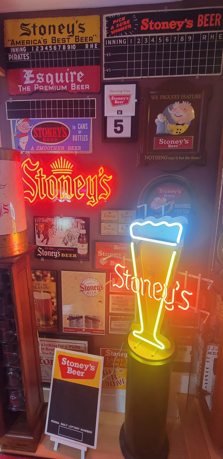 Tall corner display of Stoney's signs and neon