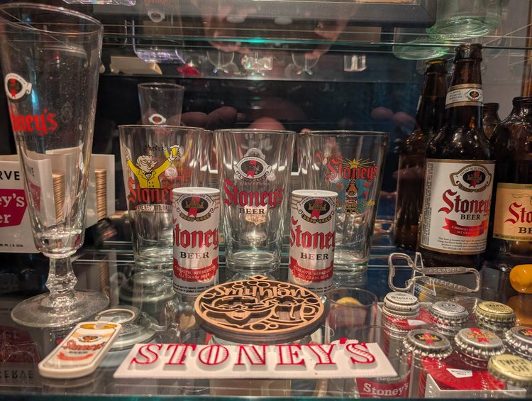 Vintage Stoney's Beer goblets, glasses, and bottle caps with a Stoney's sign