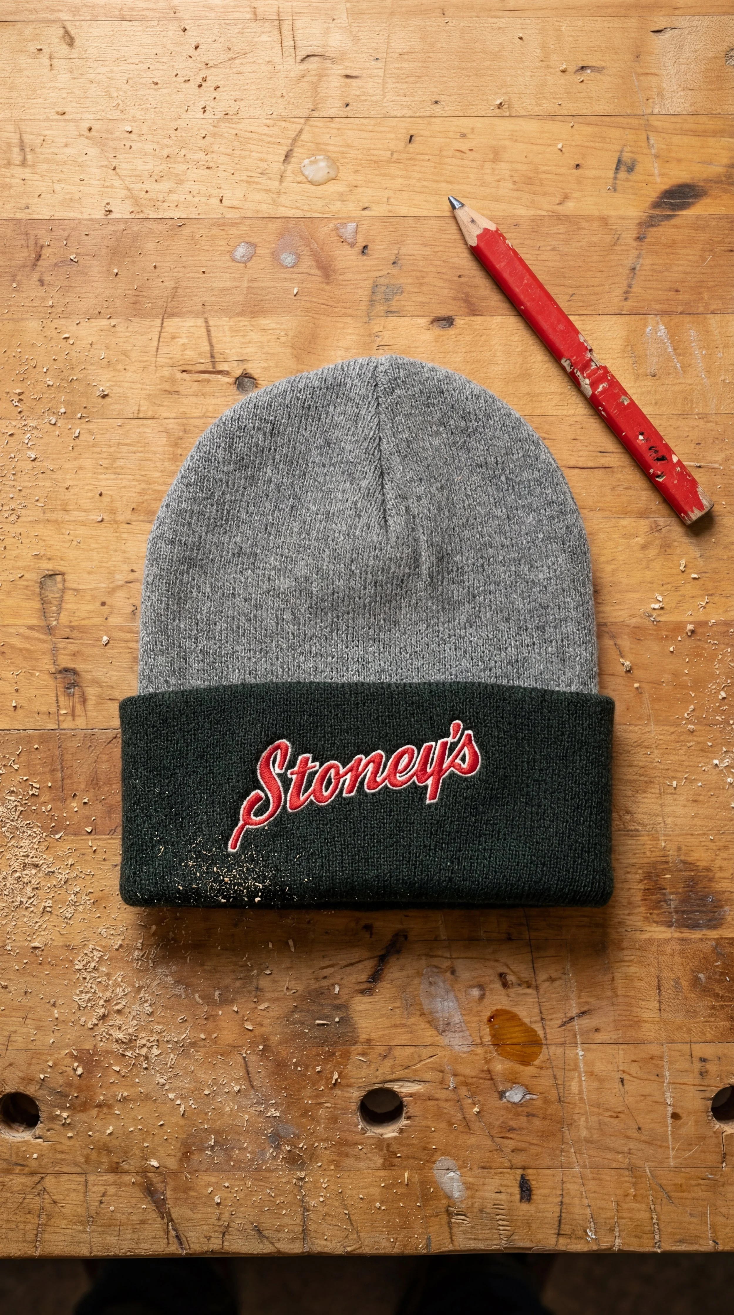 Stoney’s Built To Work knit beanie with embroidered logo on wood workbench in Pennsylvania jobsite setting