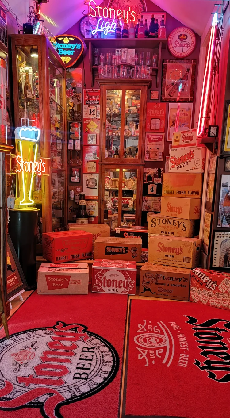 Collection room with stacked Stoney's crates and neon