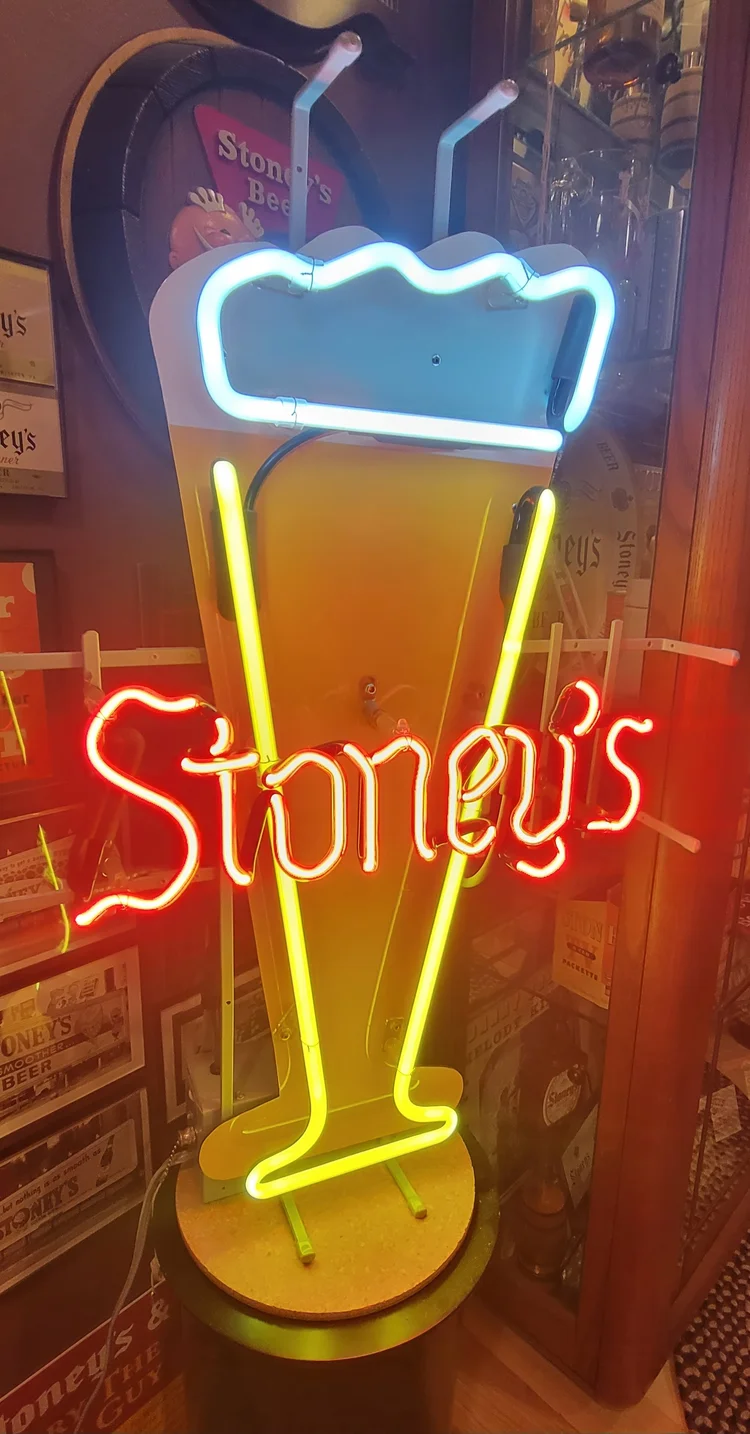 Neon Stoney's beer-glass sign glowing yellow