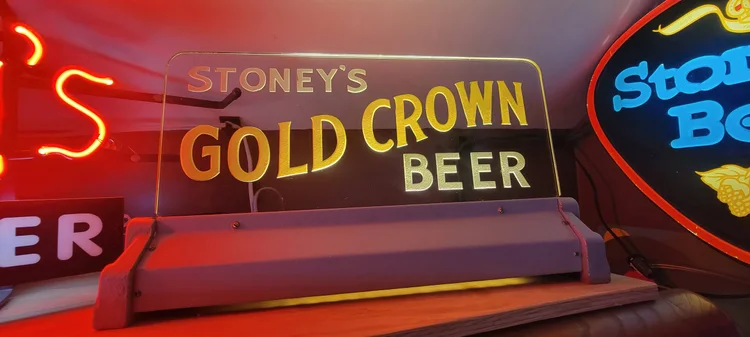 Neon Stoney's Gold Crown Beer sign among other lit signs