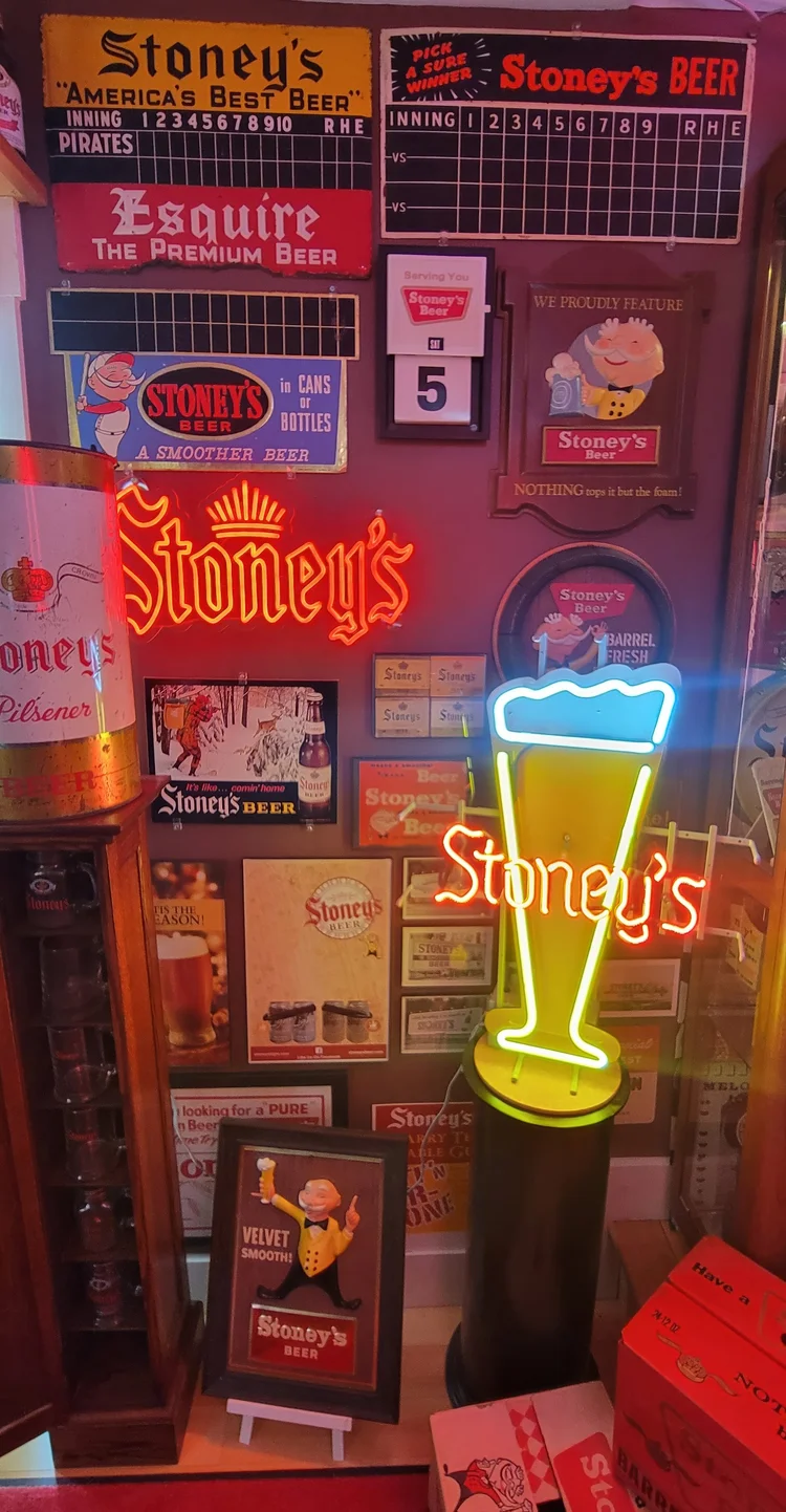 Tall display column of lit Stoney's signs and a pilsner glass sign