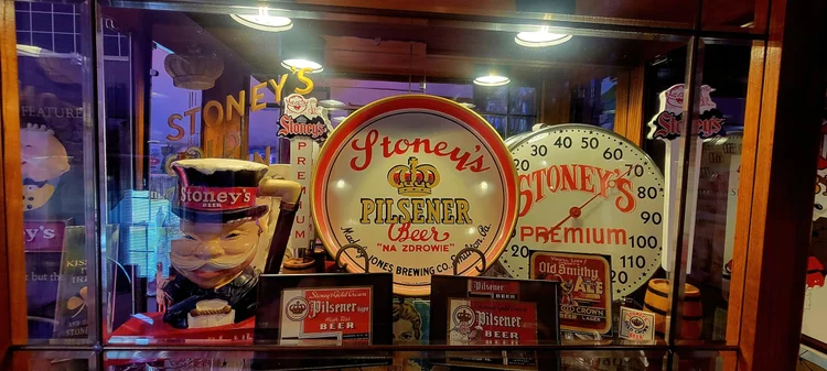 Lit display case of vintage Stoney's Pilsner and lager signs