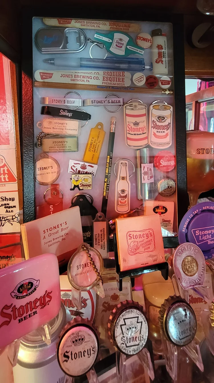 Shelf of vintage Stoney's cans, trays, and coasters