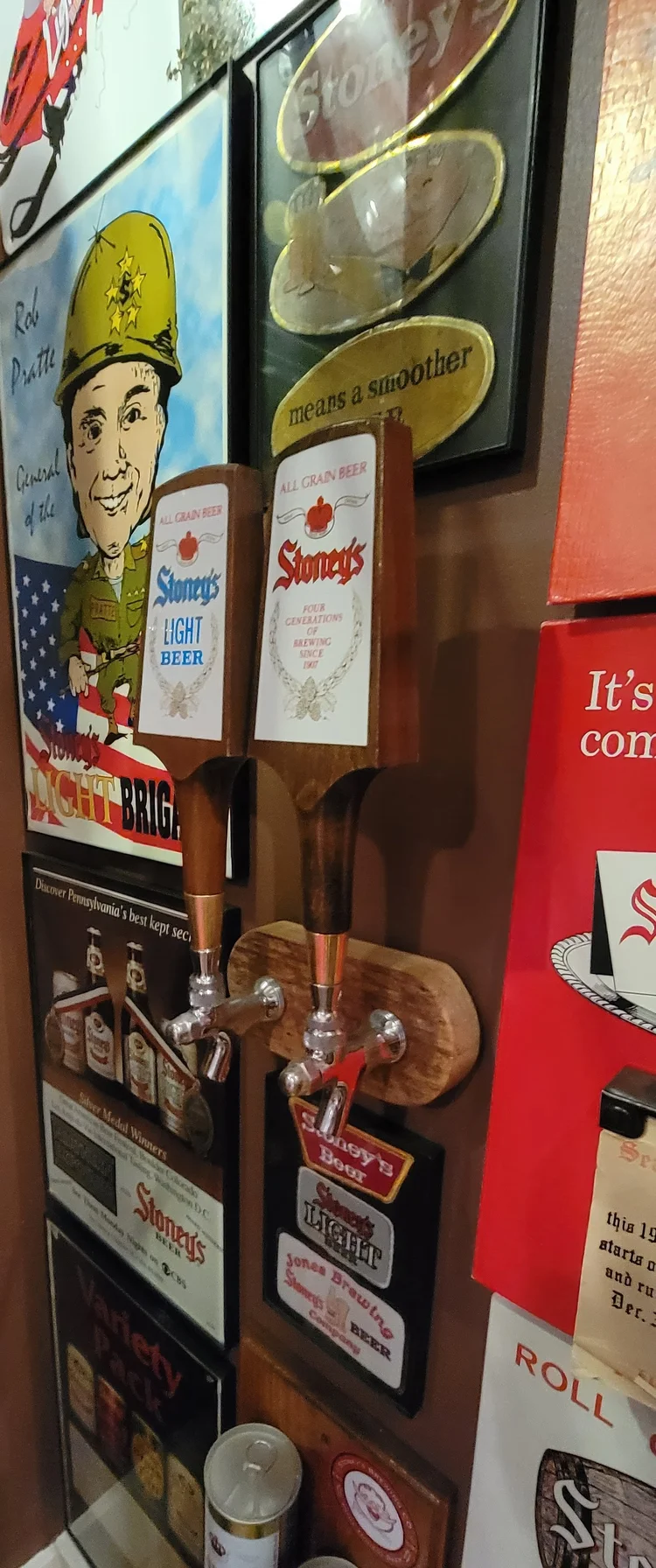 Stoney's pin-up sign and advertising mounted on a wall