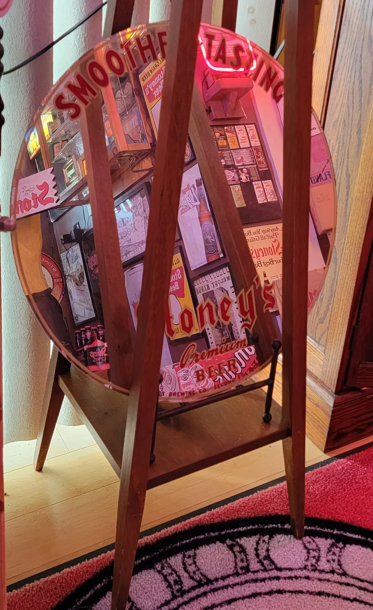 Wooden A-frame easel holding vintage Stoney's signs