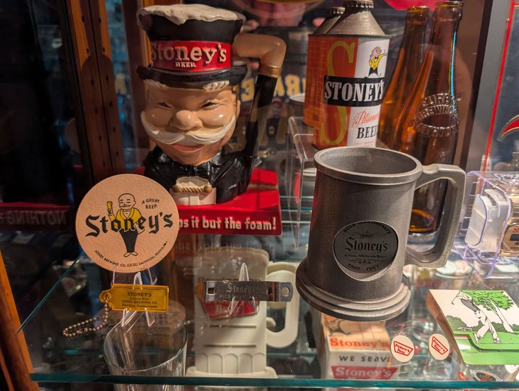 Vintage Mr. Smoothie figure and pewter Stoney's stein on a display shelf