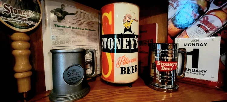 Vintage Stoney's cans, a pewter mug, and a calendar display