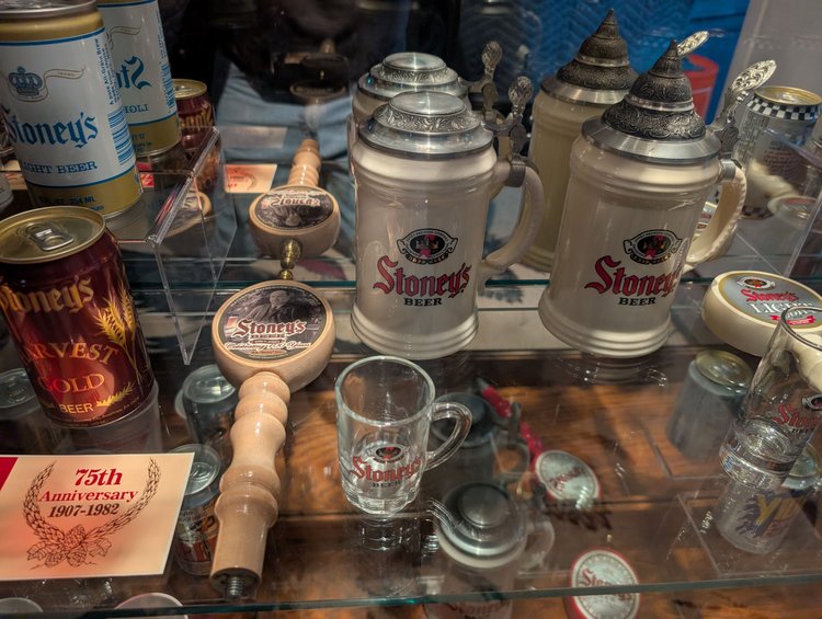 Vintage Stoney's Beer ceramic steins, cans, and a 75th anniversary coaster