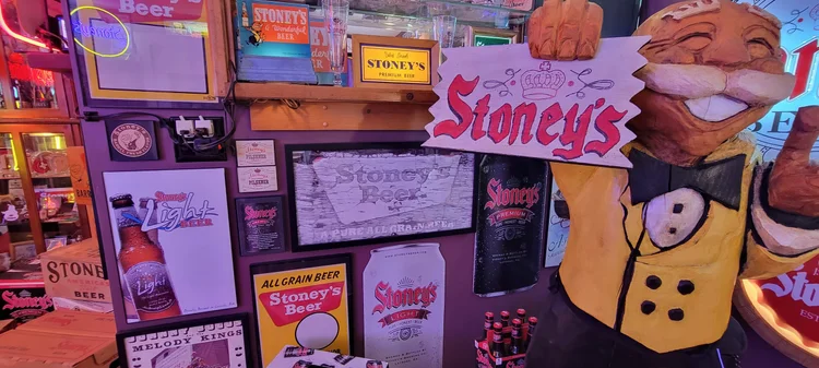 Display of Stoney's signs with a Mr. Smoothie figure in a yellow jacket