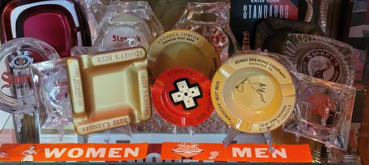 Vintage Stoney's ashtrays, coasters, and a Women and Men restroom sign