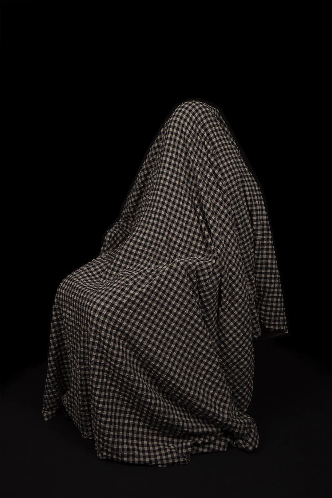 Colour photograph of a mother hidden beneath a draped piece of fabric produced by Clare Hughes Photography.