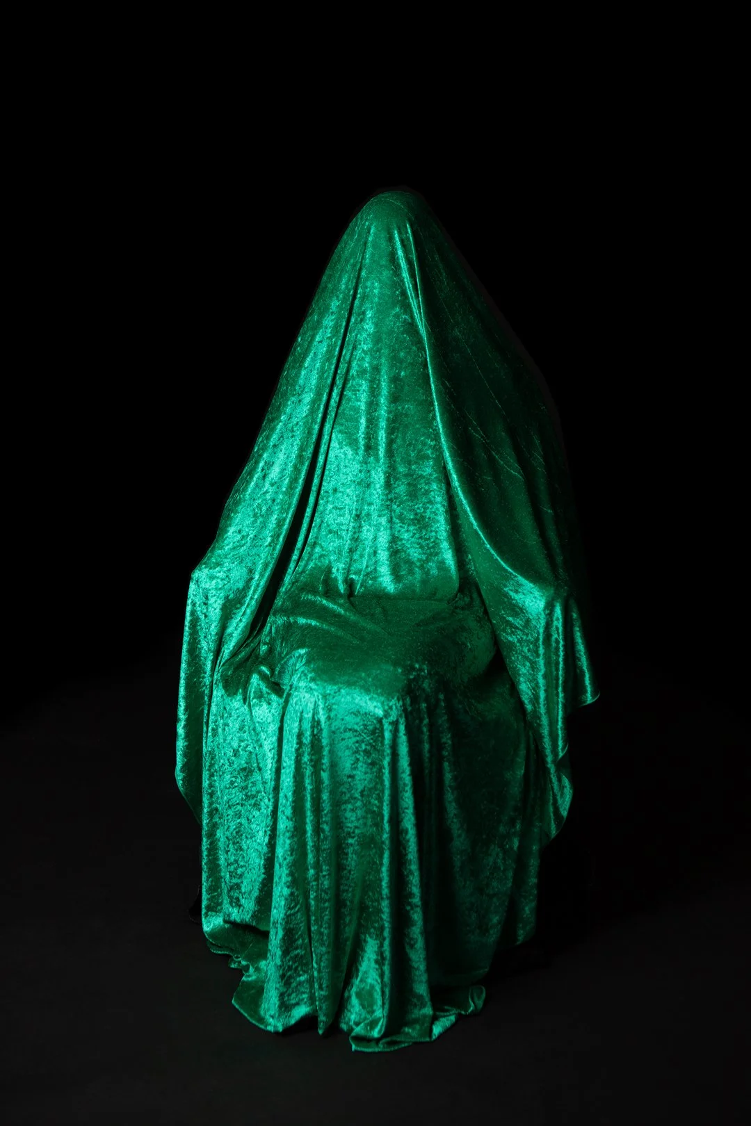 Colour photograph of a mother hidden beneath a draped piece of fabric produced by Clare Hughes Photography.