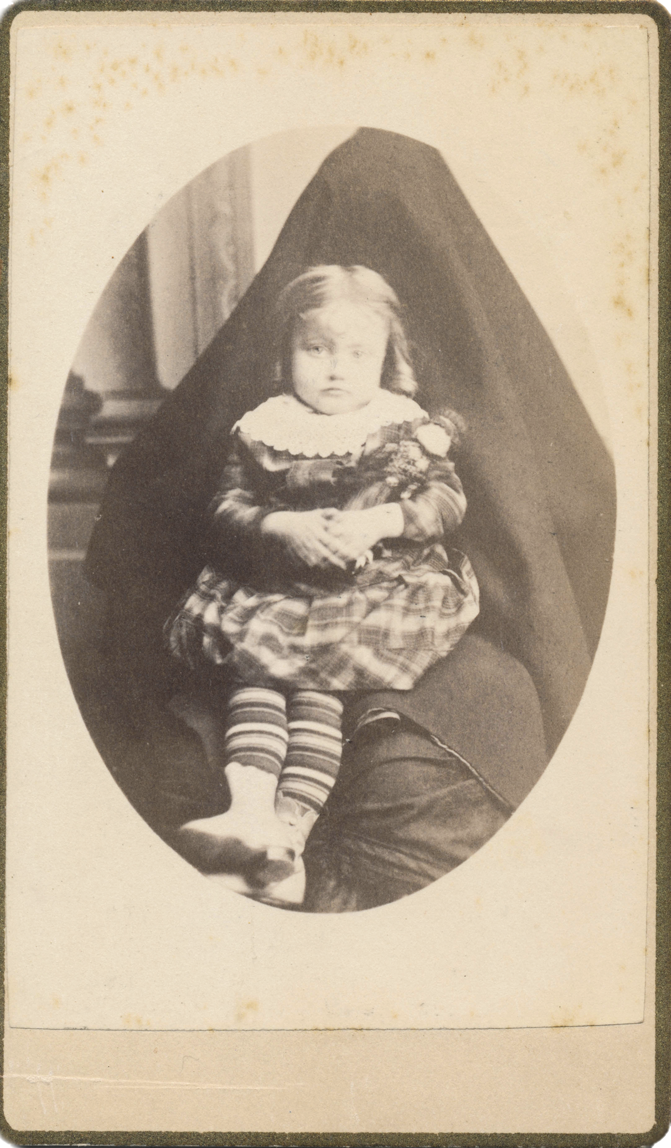 Antique photograph of an infant with a hidden mother by photographer J.C. Elrod.