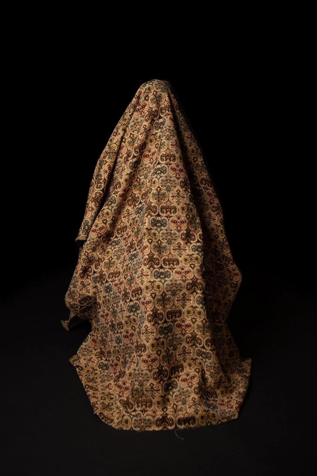 Colour photograph of a mother hidden beneath a draped piece of fabric produced by Clare Hughes Photography.
