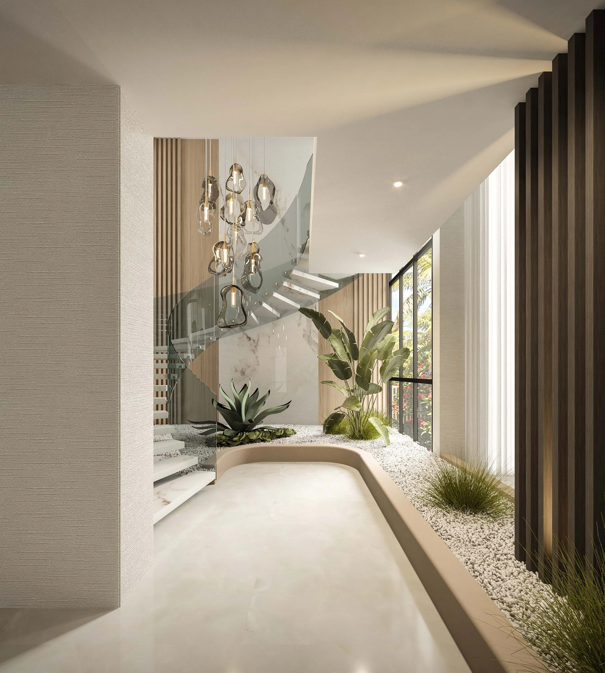 A double-height entryway designed to make a striking first impression, featuring a sculptural floating staircase, vertical wood detailing, and a statement chandelier. Natural light and curated greenery enhance the connection to the coastal surroundin