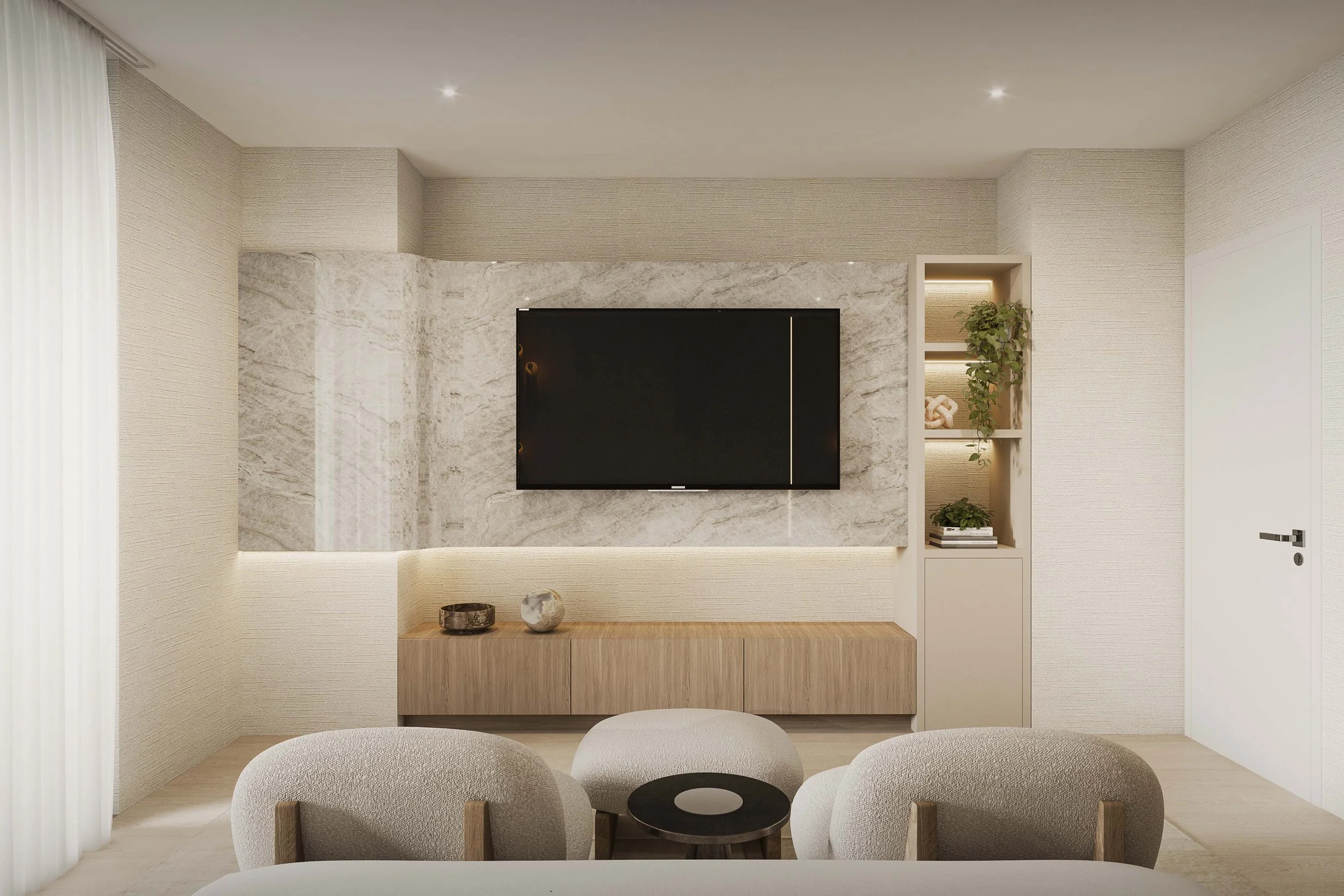 A sophisticated primary bedroom featuring a custom stone accent media wall that anchors the space with texture and depth. A dedicated seating area adds an extra layer of comfort and functionality, while soft neutral tones and refined finishes create 