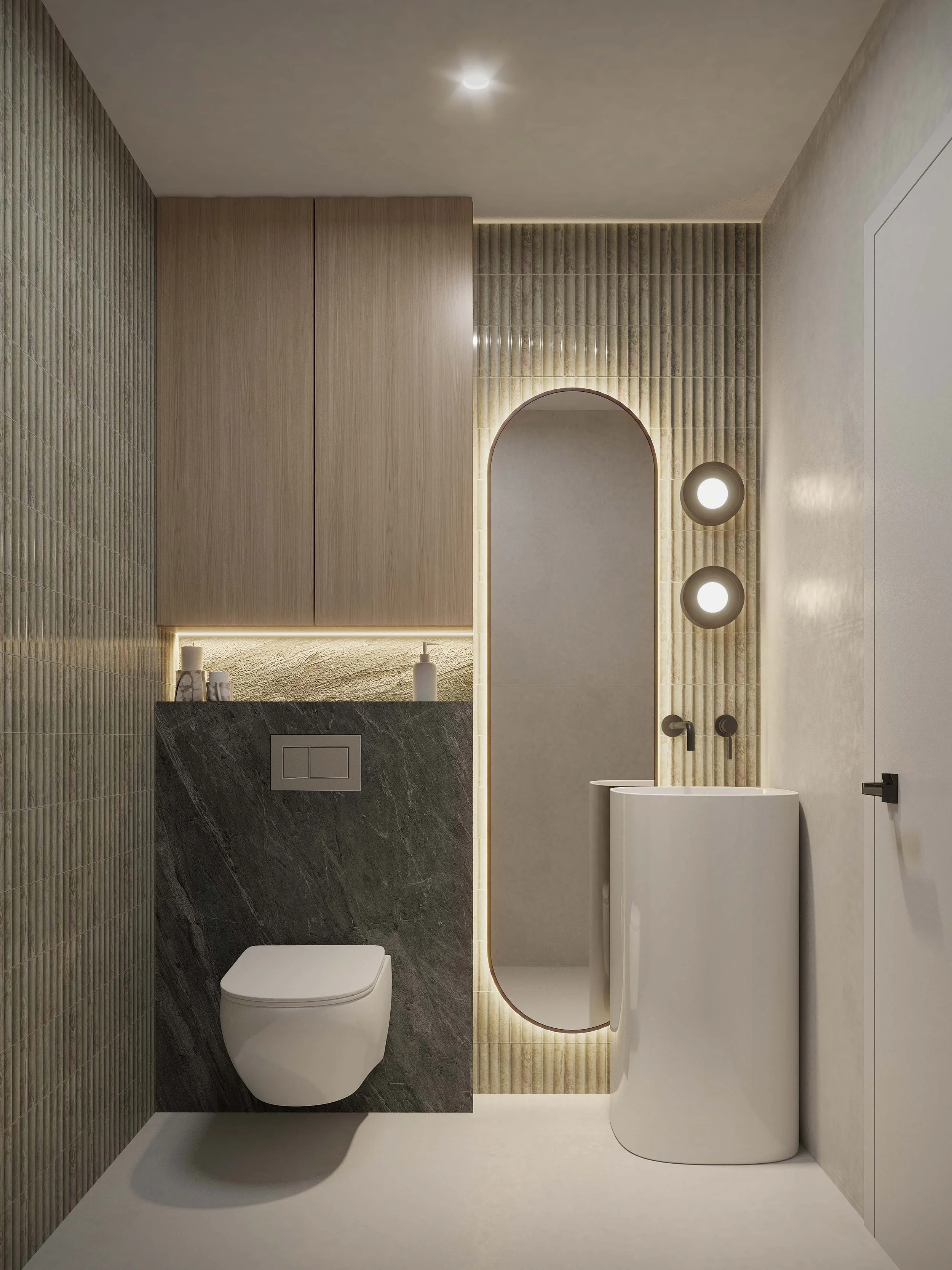 A bold powder bathroom featuring a large freestanding vanity in green stone that serves as a striking focal point. An oval mirror softens the composition, while custom storage behind the toilet adds functionality without disrupting the clean design. 