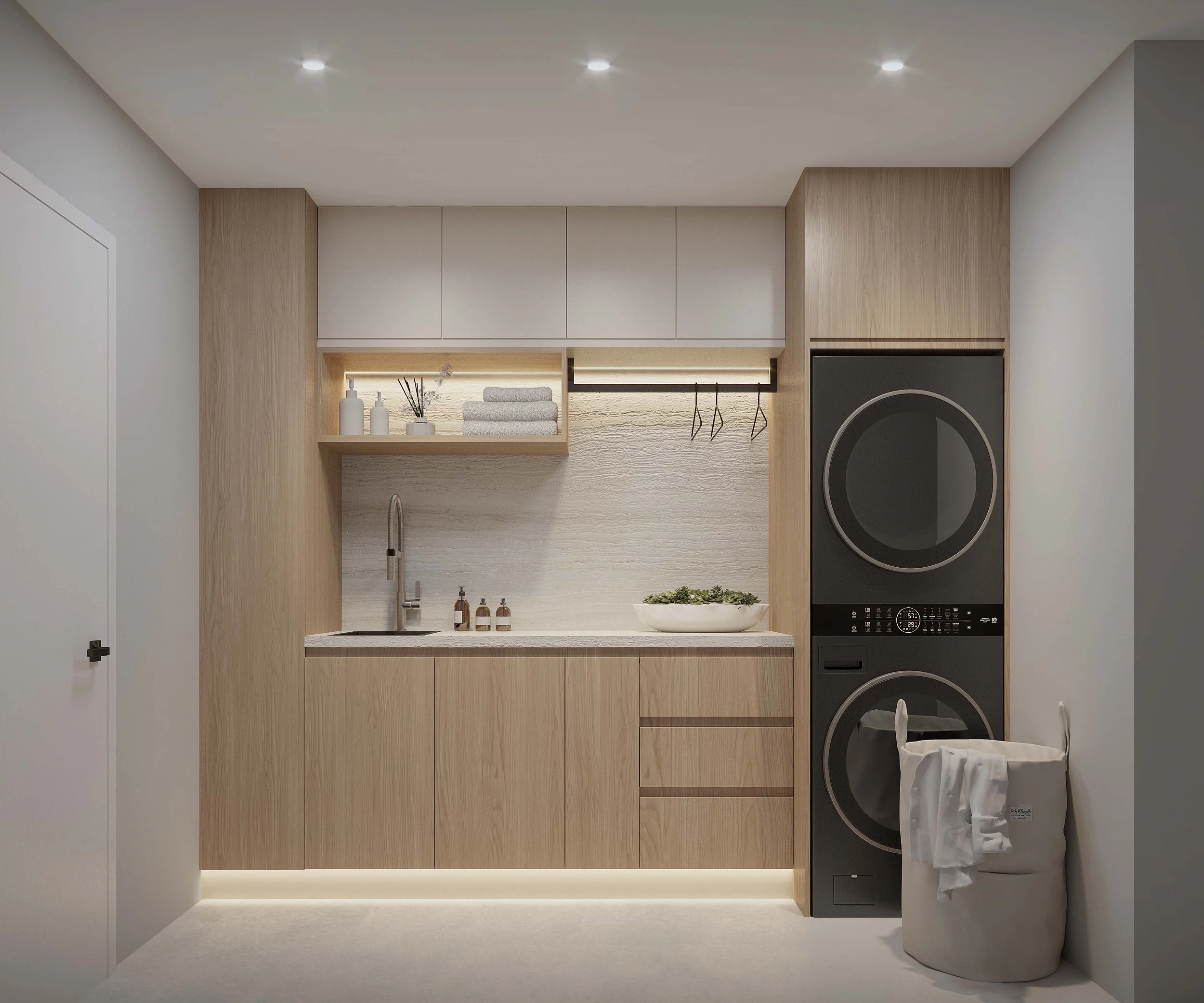 A custom built laundry space featuring warm wood cabinetry and an integrated sink, designed to maximize both functionality and organization. Clean lines and tailored storage solutions create a streamlined look, elevating everyday utility within a mod