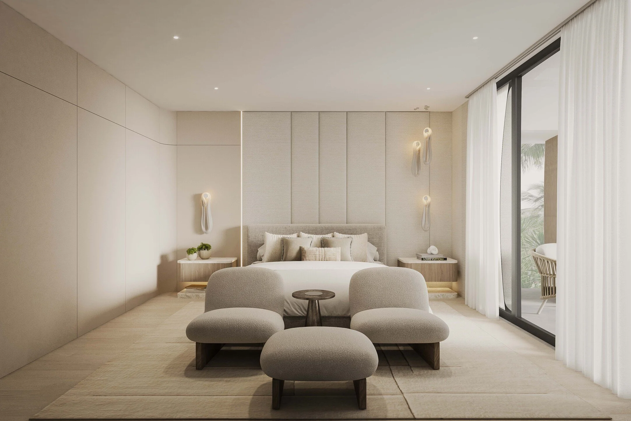 A sophisticated primary bedroom featuring a custom stone accent media wall that anchors the space with texture and depth. A dedicated seating area adds an extra layer of comfort and functionality, while soft neutral tones and refined finishes create 