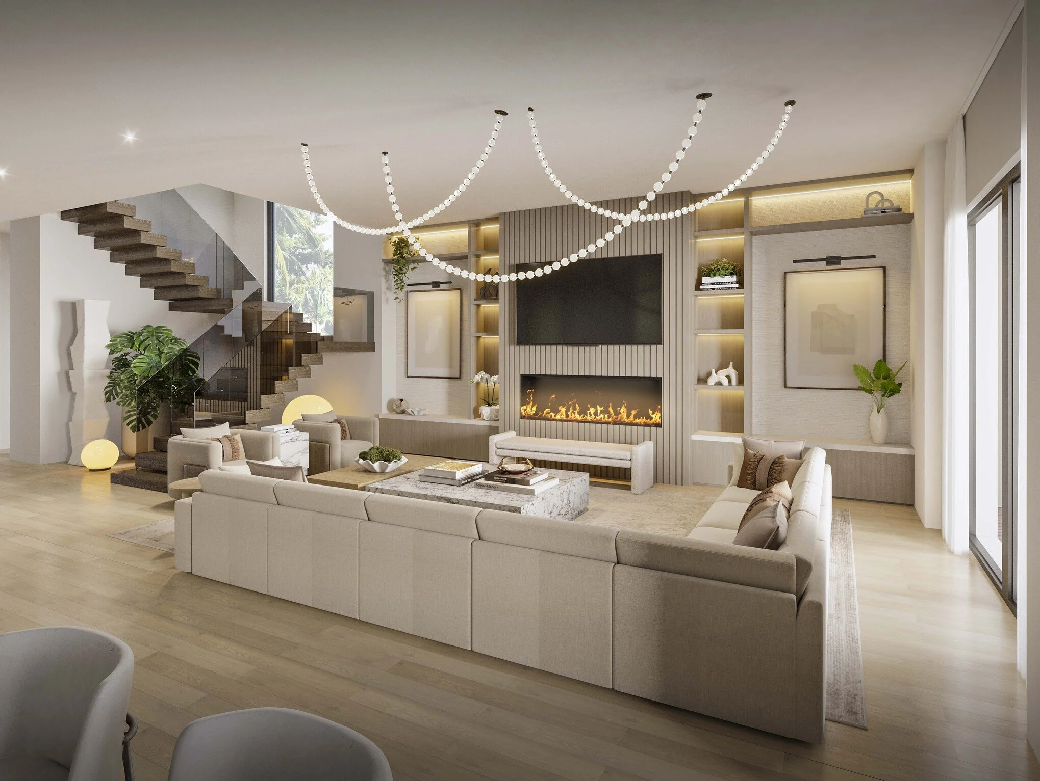 A spacious family room centered around a large sectional that invites comfort and gathering. A custom media wall with built-in cabinetry and a fireplace creates a warm focal point, while a statement chandelier adds a layer of sophistication. Clean li