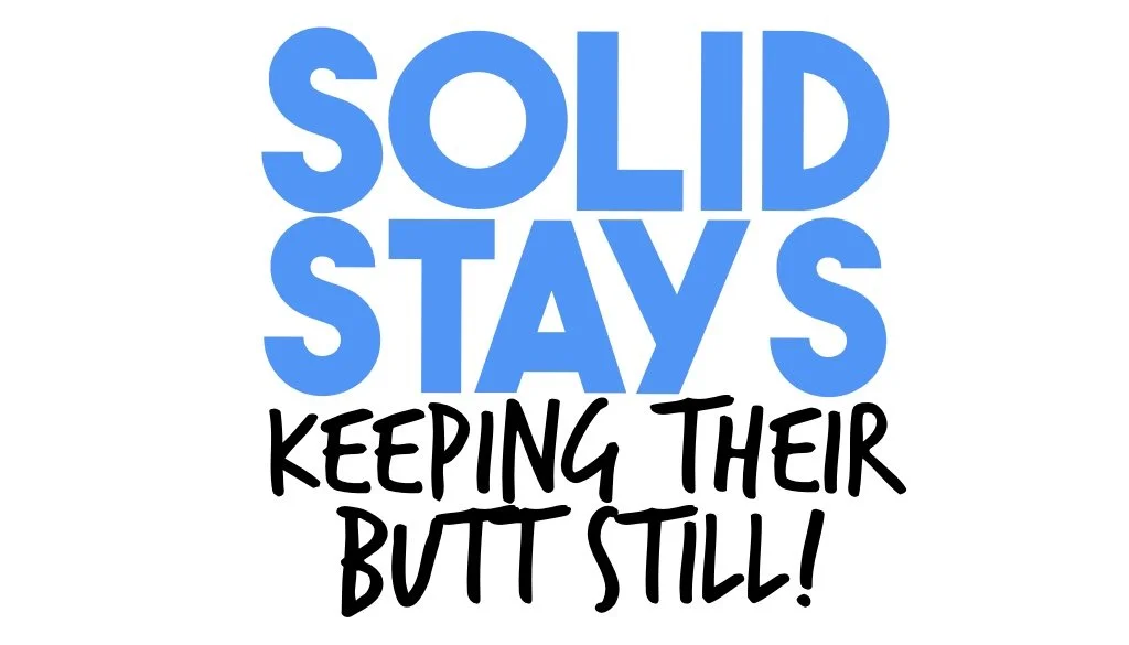 A humorous sign with the text "Solid Stays Keeping Their Butt Still!" in blue and black fonts.