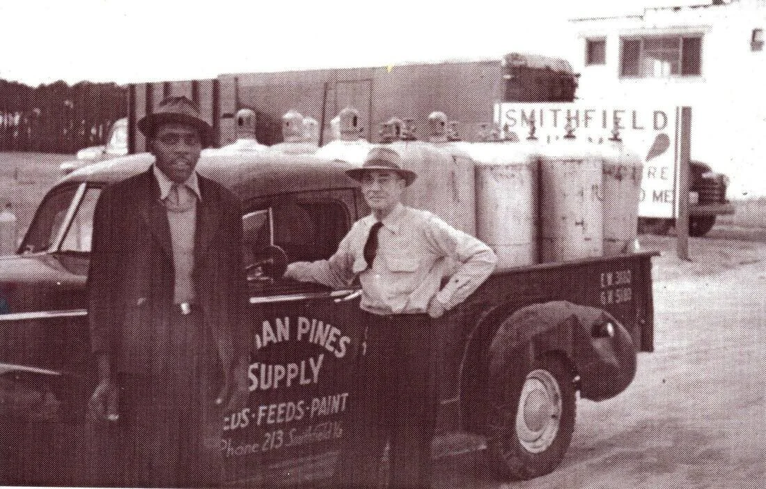1950s-mr-atkins-left-who-was-known-to-be-the-strongest-man-in-smithfield-standing-with-jack-grimes-who-owned-several-businesses-in-the-town_orig.jpg
