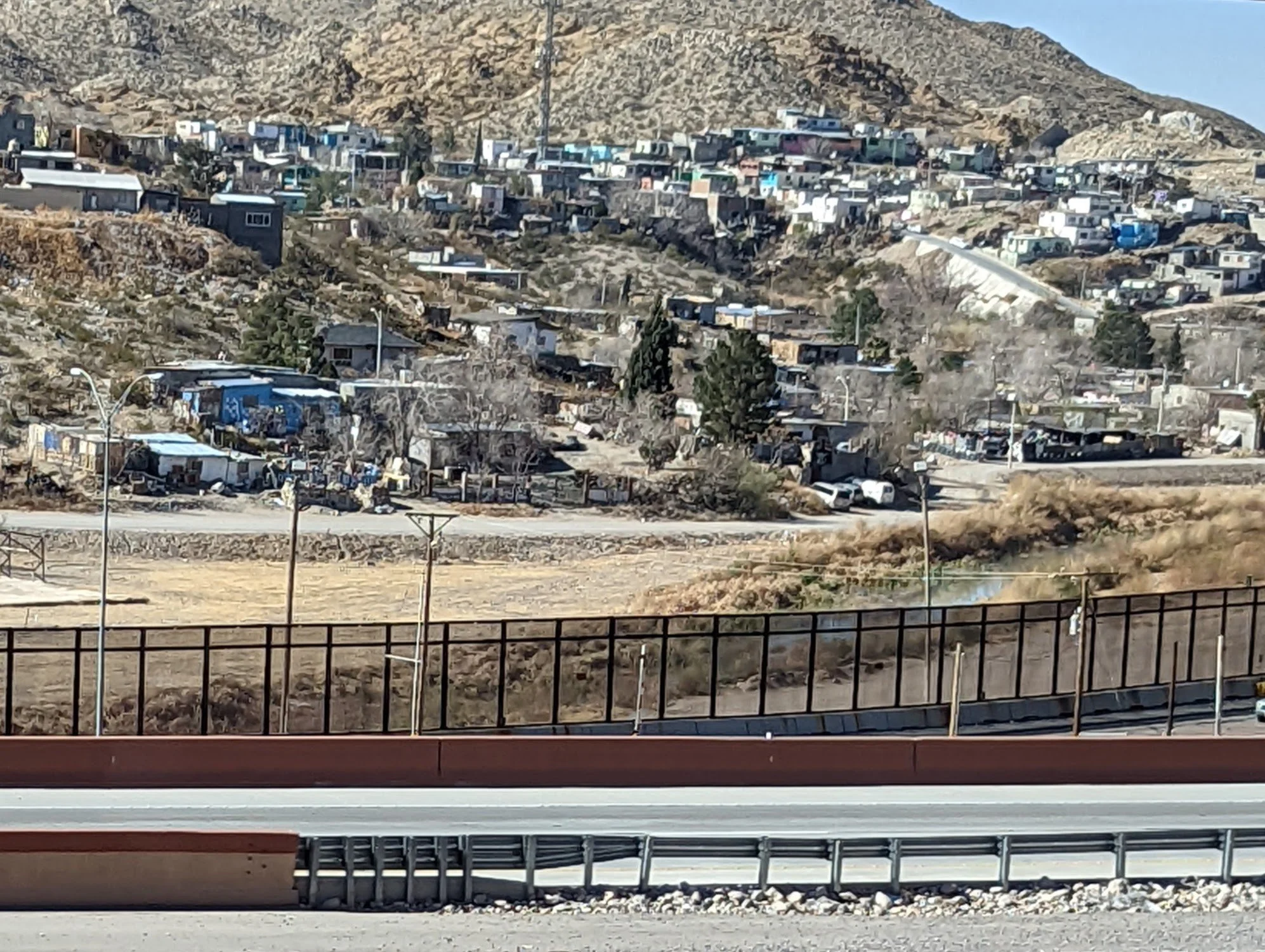 The border "wall" fence in the foreground Mexico beyond, from El Paso
