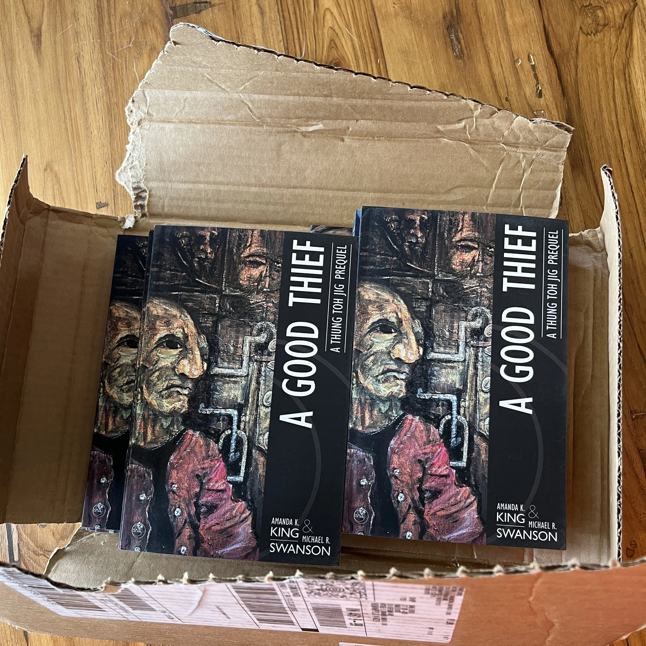 A Good Thief novella trade paperback being unboxed