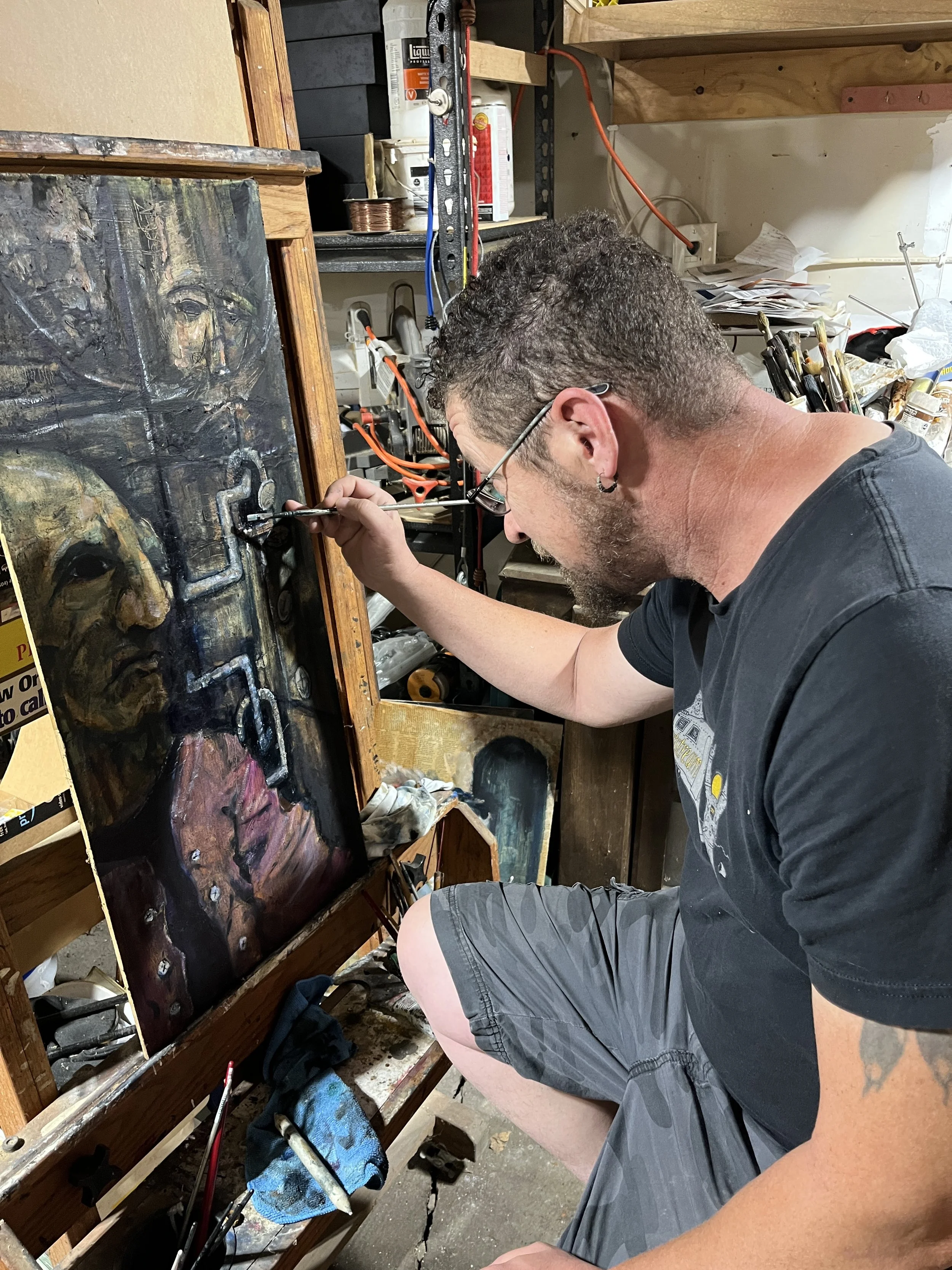 Michael-b-fee-at-easel-painting-bettel-hand-cover-painting-they-eat-their-own.jpg