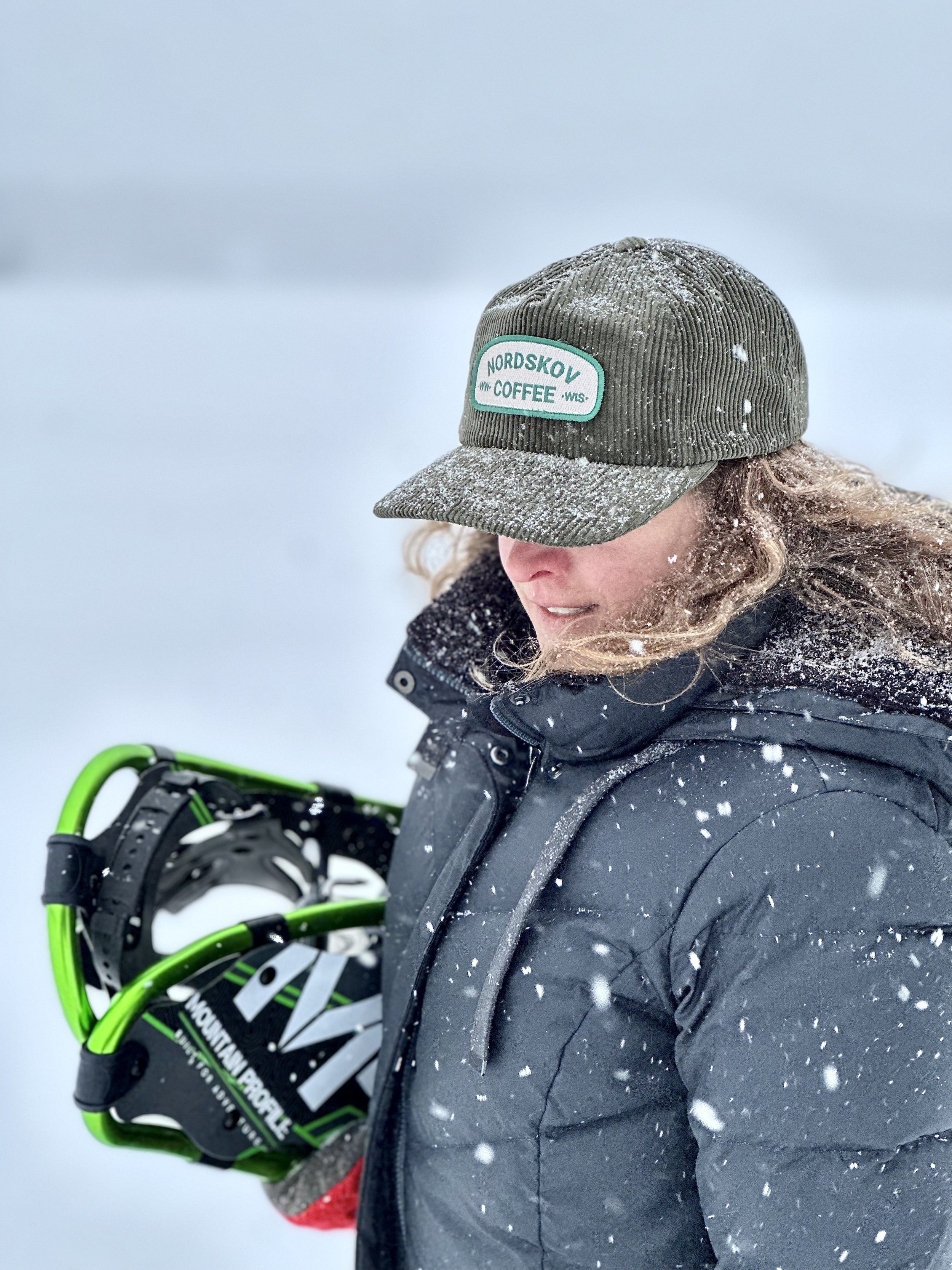 Nordskov Wide Wale Corduroy Hat in the snow