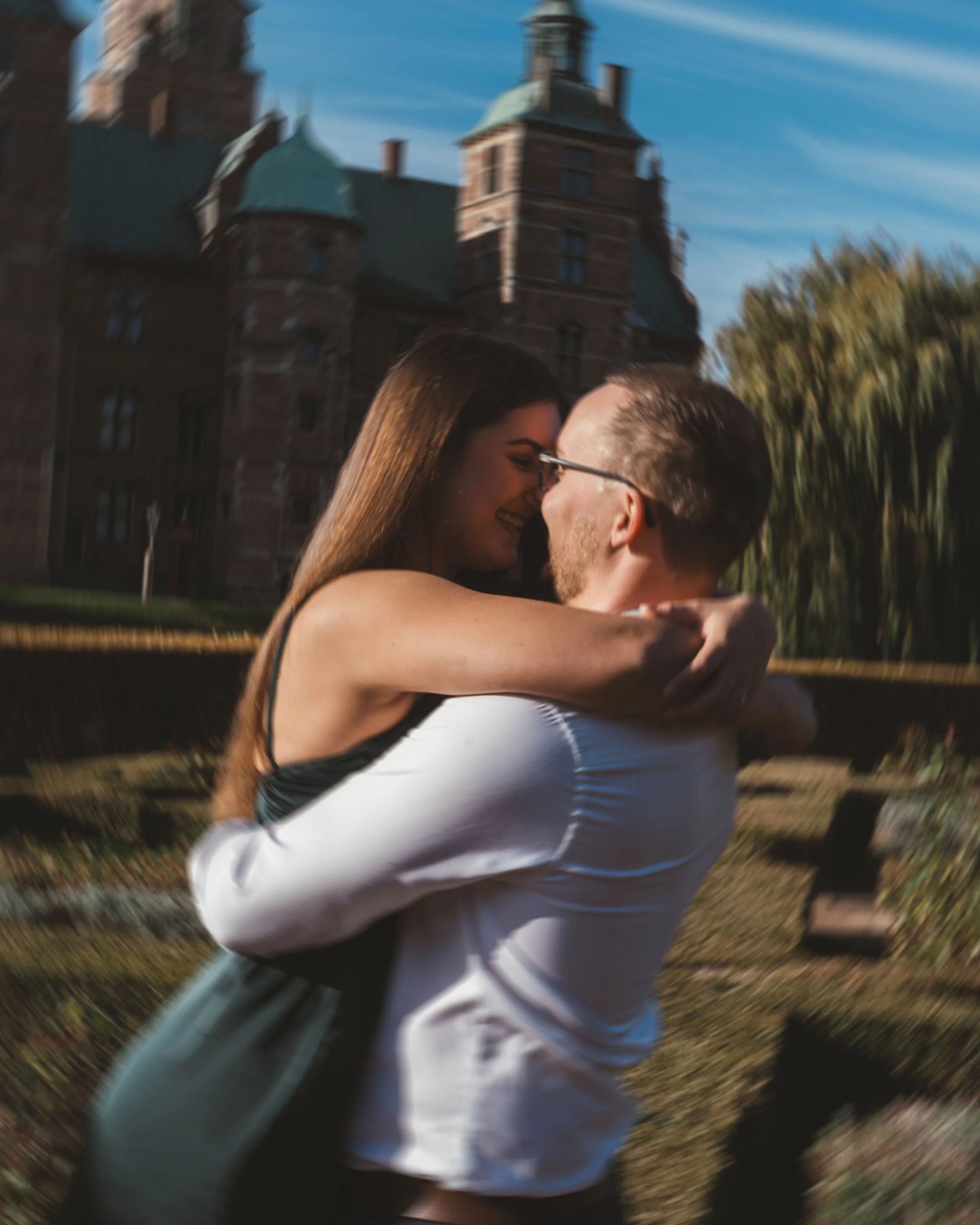 Engagement photo session in Copenhagen at sunset with couple laughing together