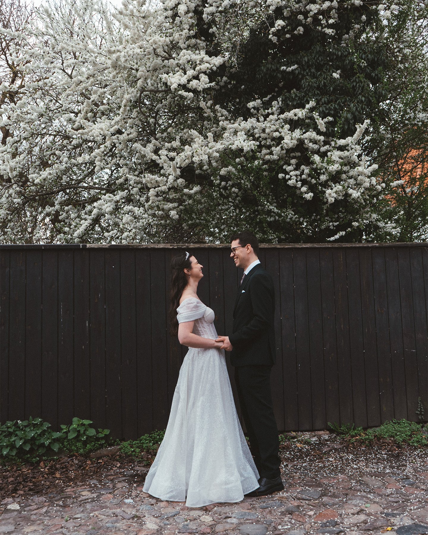 Couple standing by the fountain in the quiet Royal Library Garden in Copenhagen.