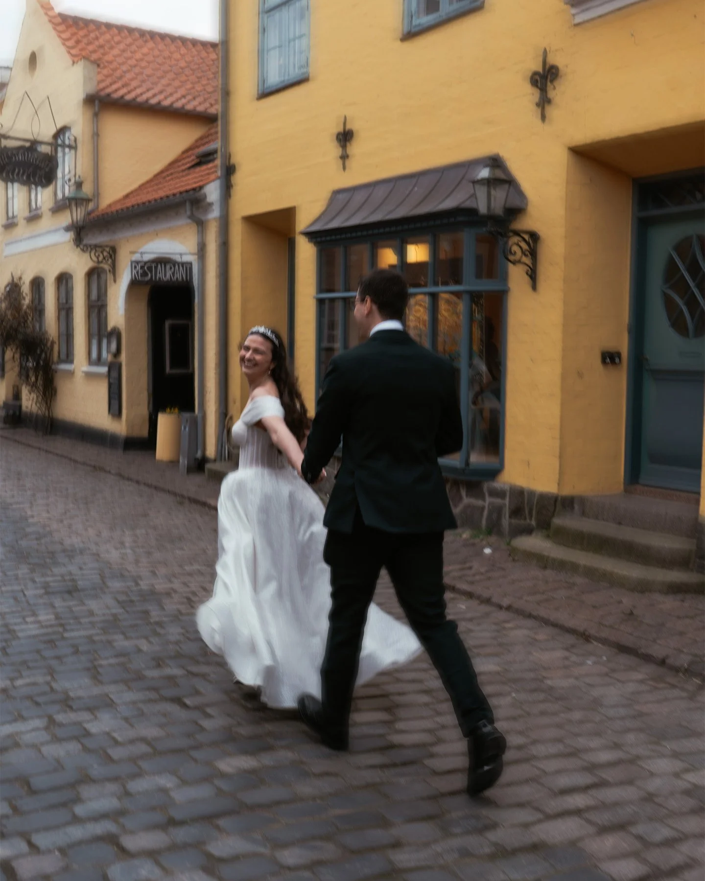 Couple walking through town during an elopement on Ærø island