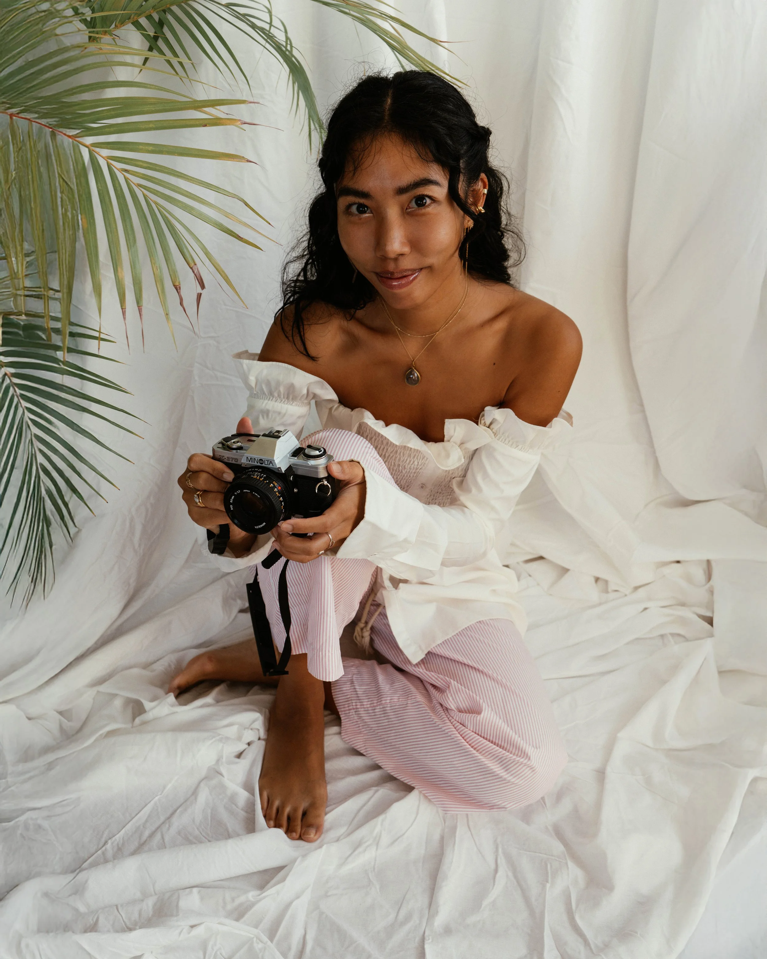 Portrait of Sharena, a Copenhagen-based photographer specialising in travel, lifestyle, fashion, couples, wedding, engagement, proposals, and editorial photography, captured in natural light with a calm, cinematic aesthetic.