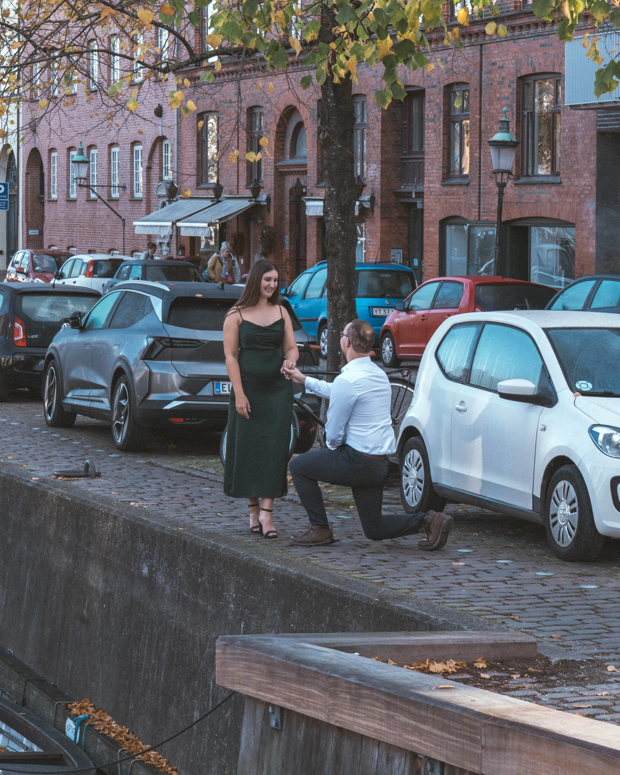 Proposal photography in Copenhagen capturing a real engagement moment along the Christianshavn canals with natural emotion.