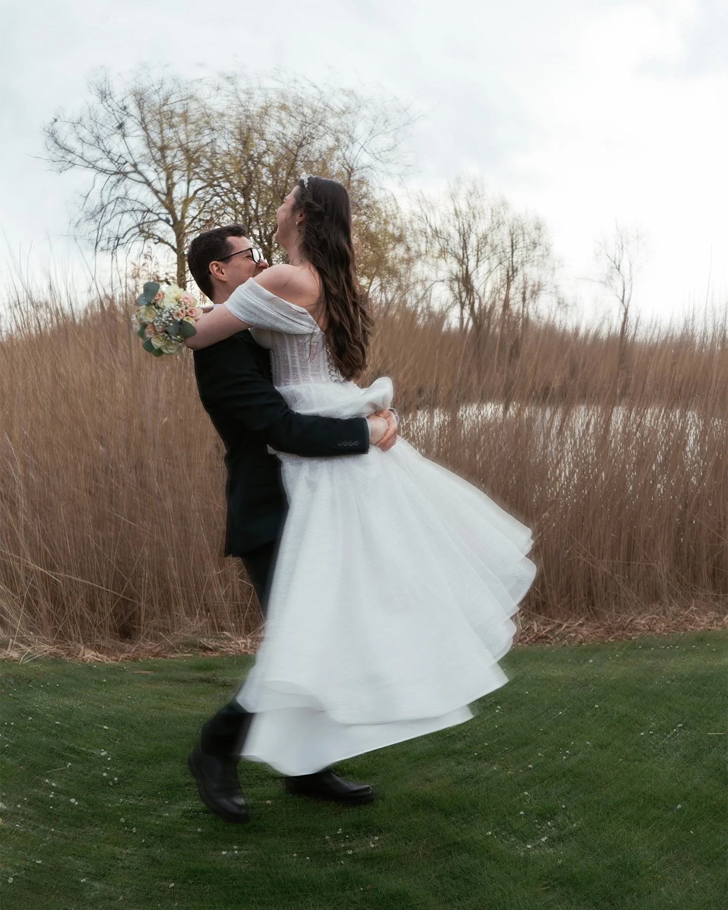 Wedding couple walking down Magstræde, one of the oldest cobblestone streets in Copenhagen.