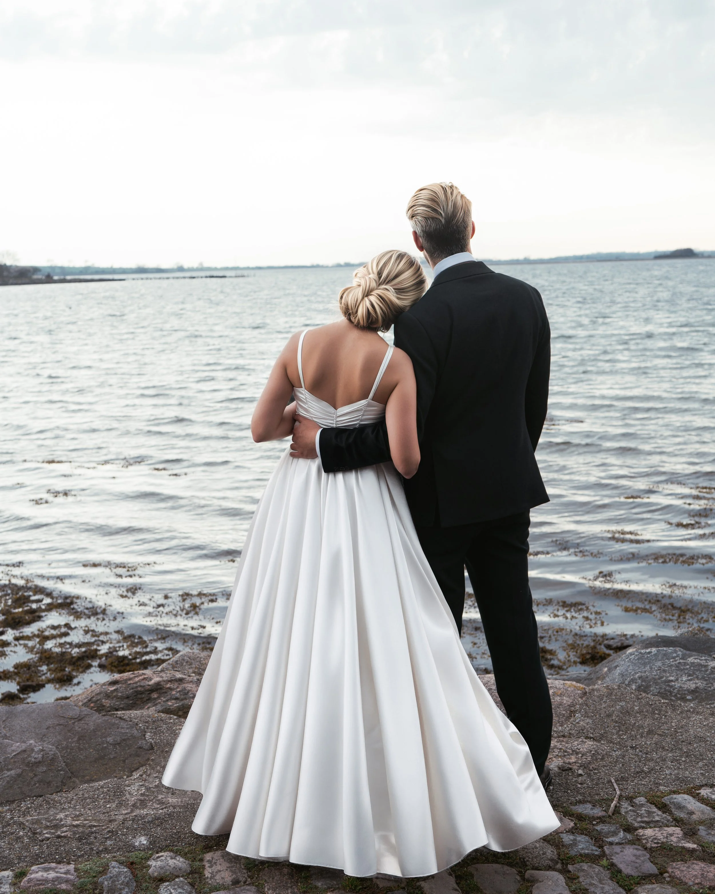 Bride and groom laughing together during relaxed wedding portraits in Copenhagen