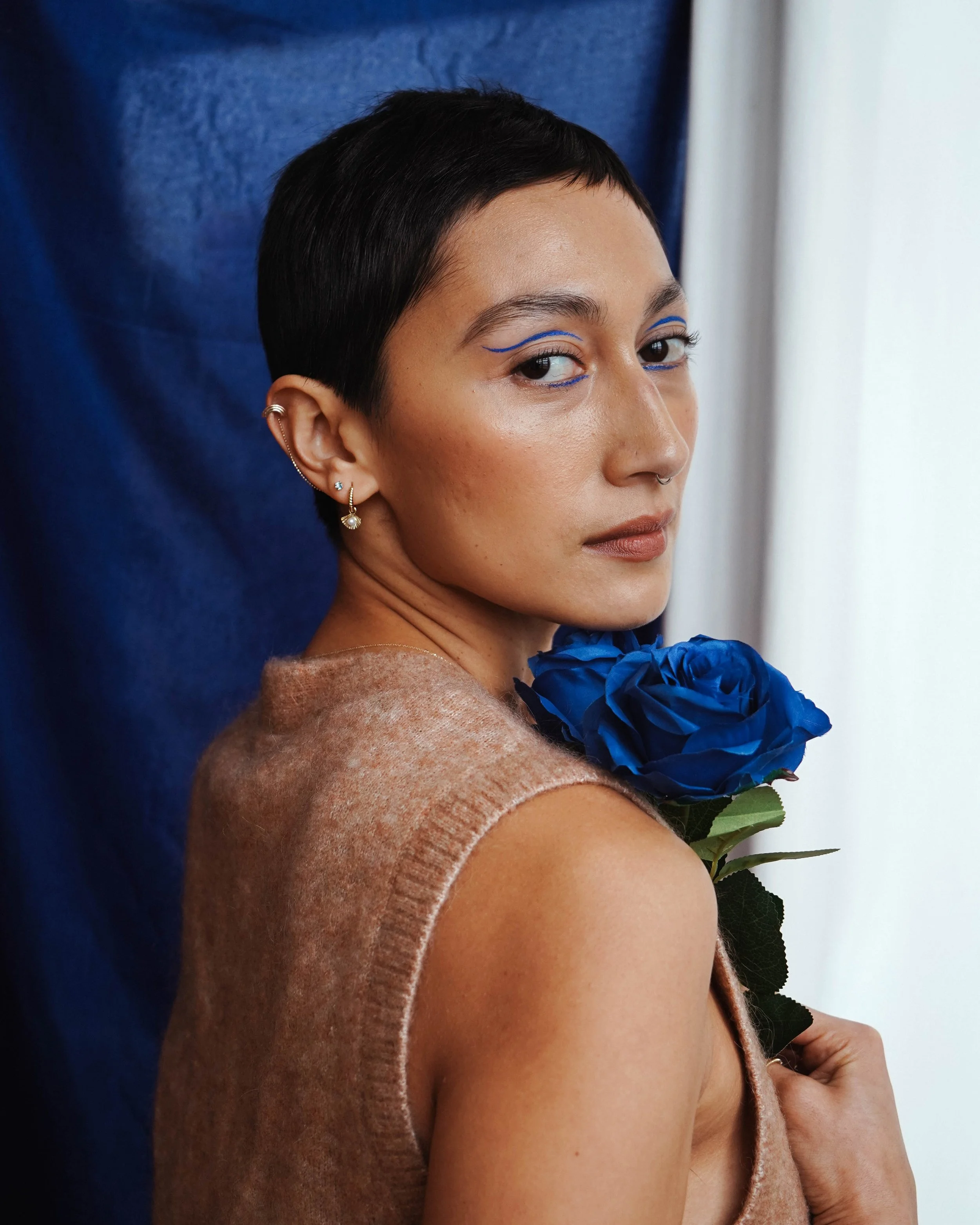Solo model in a studio setting wearing jewellery, captured with editorial lighting and contemporary fashion style.