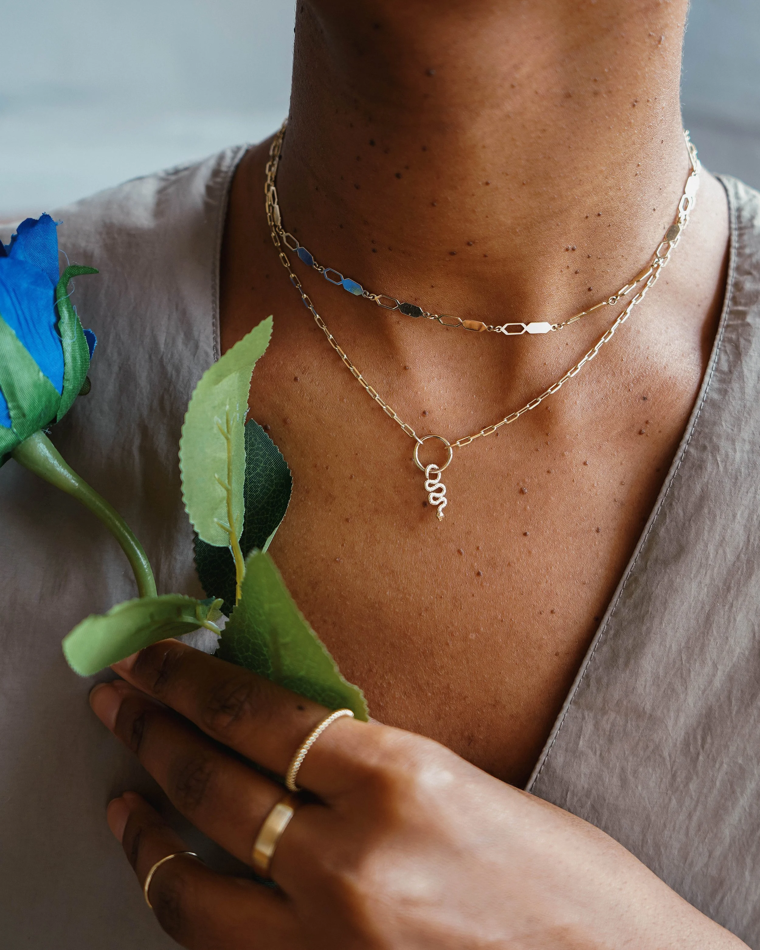 Non-binary model in studio showcasing jewellery with a modern, editorial fashion approach.