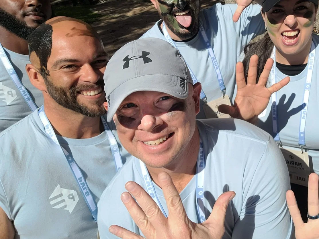 Jeremy, a military veteran, poses with some of his veteran friends at a leadership and development conference meant to help the military community grow in their careers. 