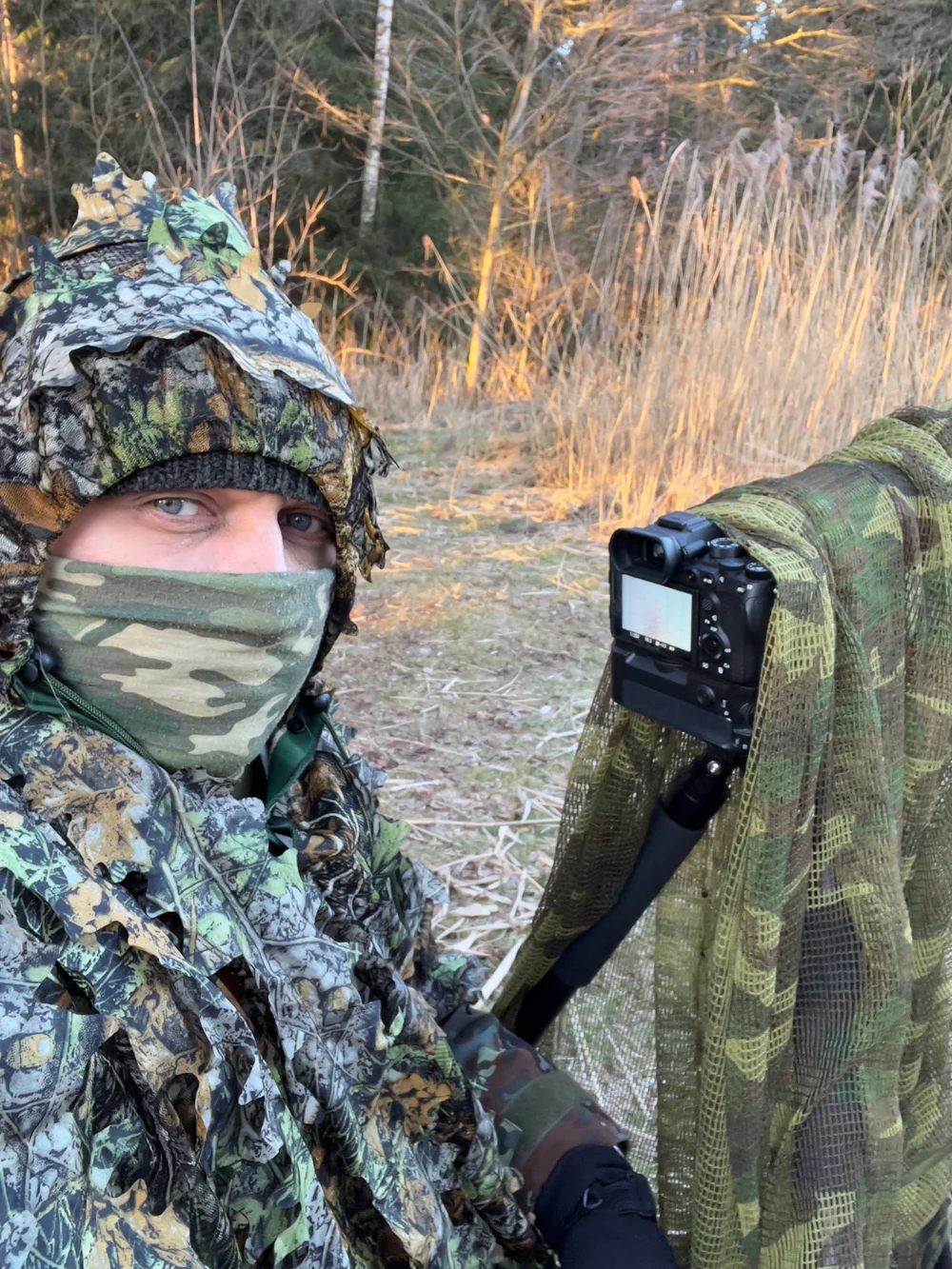 Photographer in 3D Camouflage Near Pond