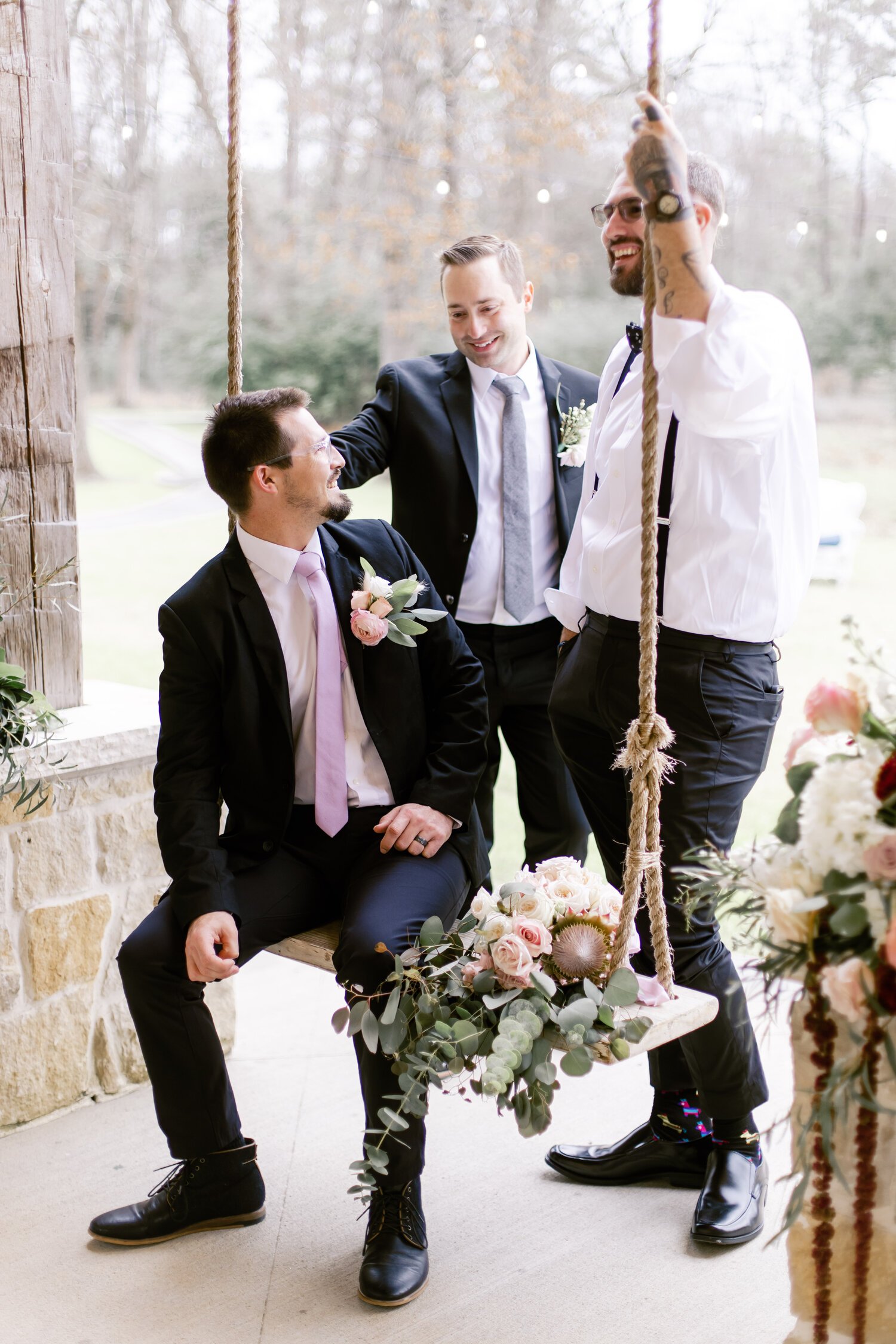  candid photo of groom and groomsmen talking 