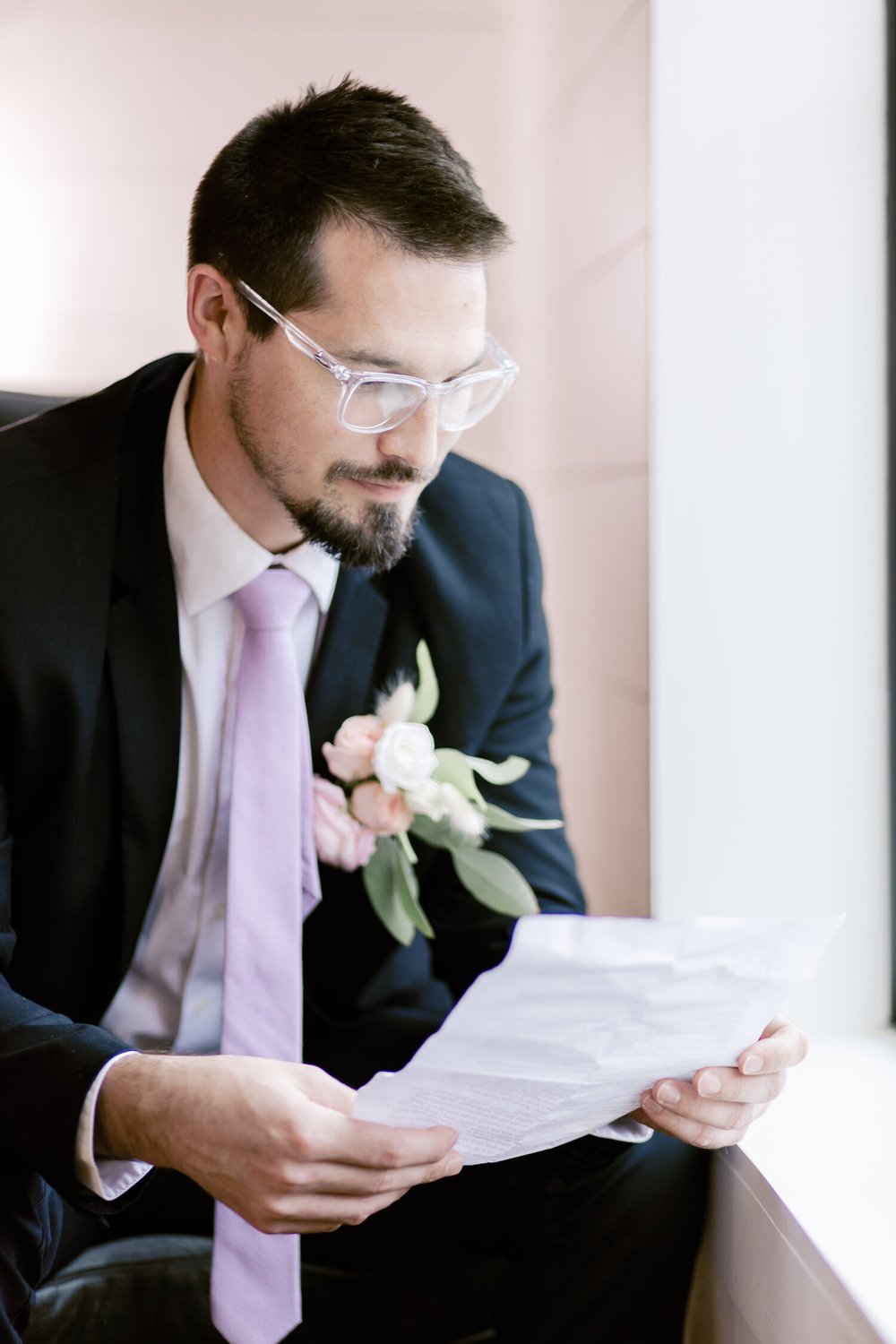  groom reading over his wedding vows 