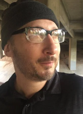 Joel Dane 
Joel Dane is the pseudonym a middle grade writer picked when he decided to write CRY PILOT (Ace), the first in a violent, action-filled military SF series about a tight-knit squad fighting rogue bio-weapons that is not appropriate for ten