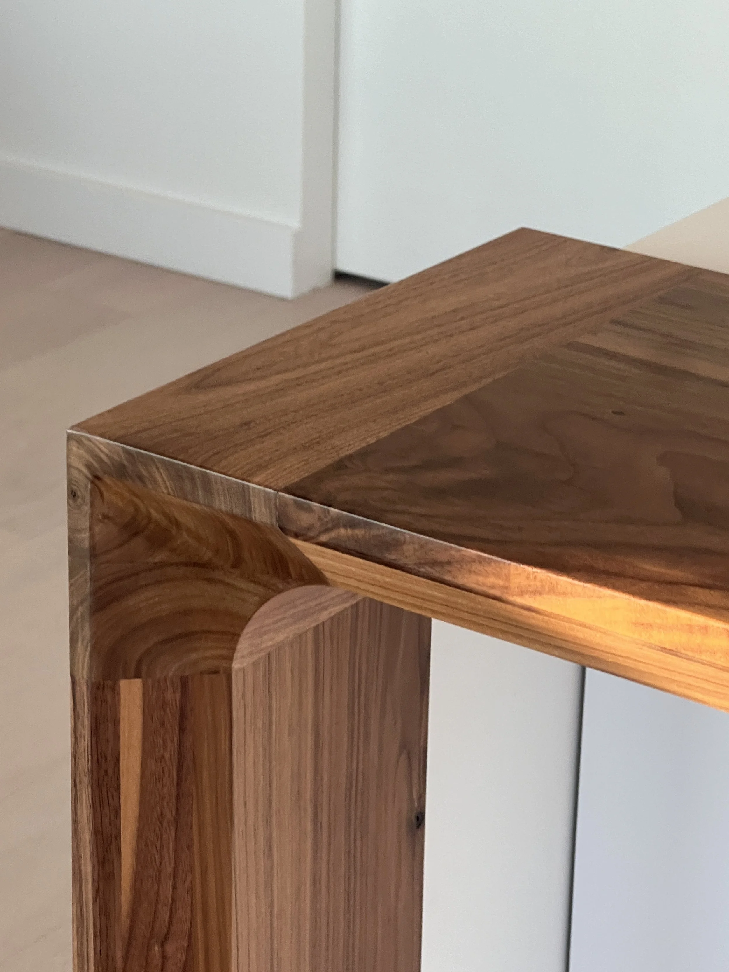 Precision mitered walnut island waterfall joinery detail