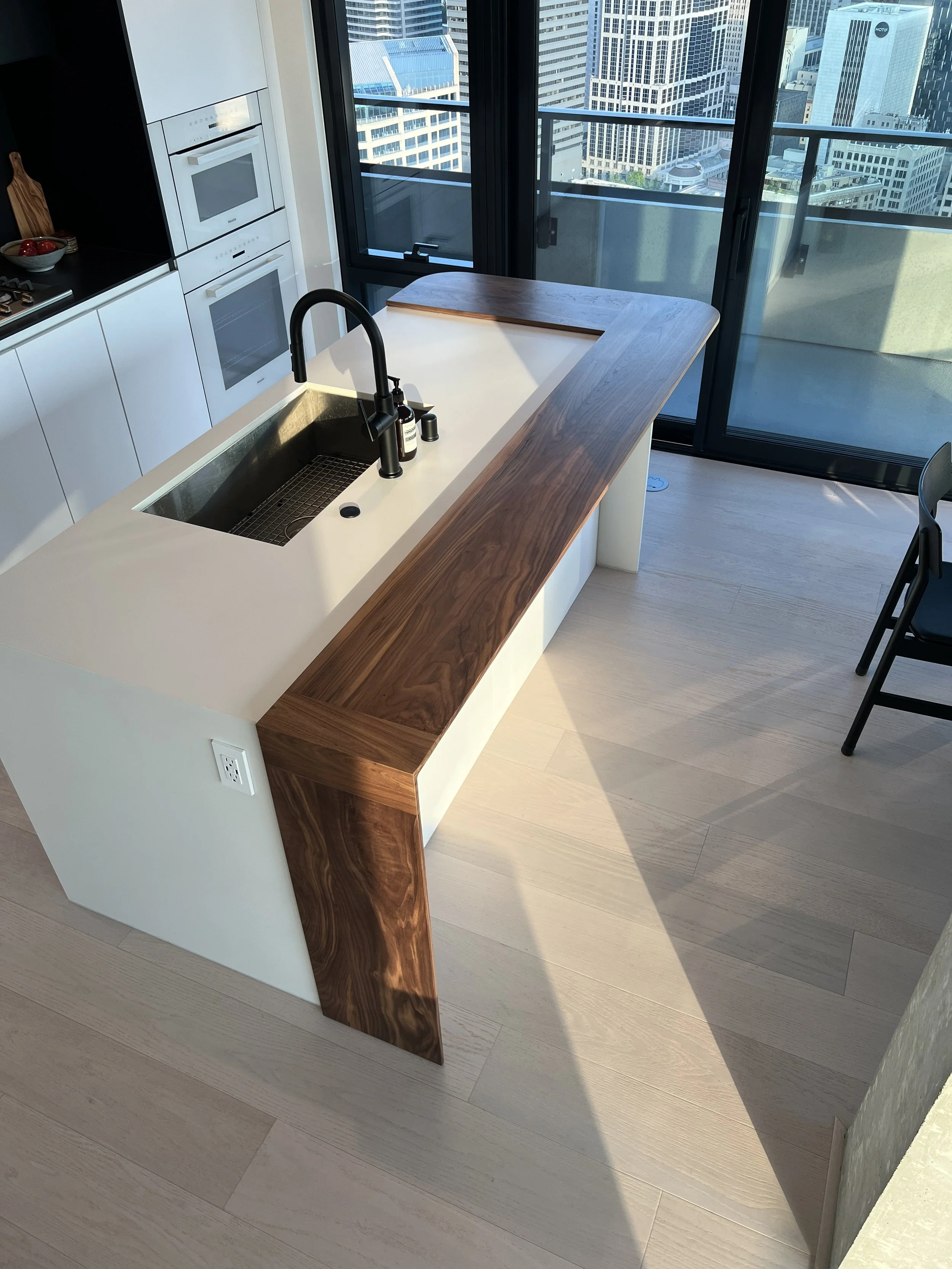 Custom walnut waterfall island First Light Seattle luxury kitchen