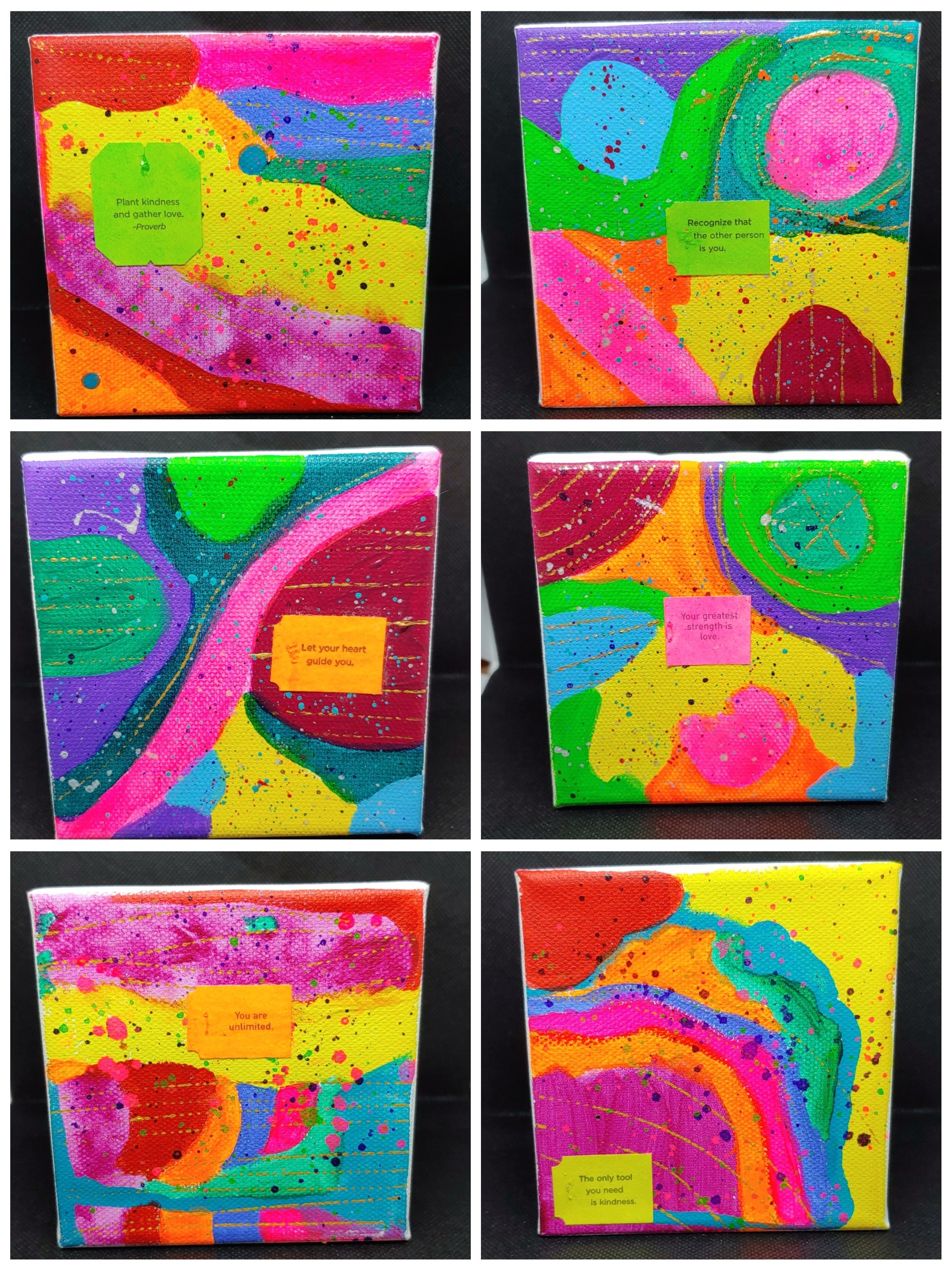Colorful abstract paintings with motivational quotes on each canvas.