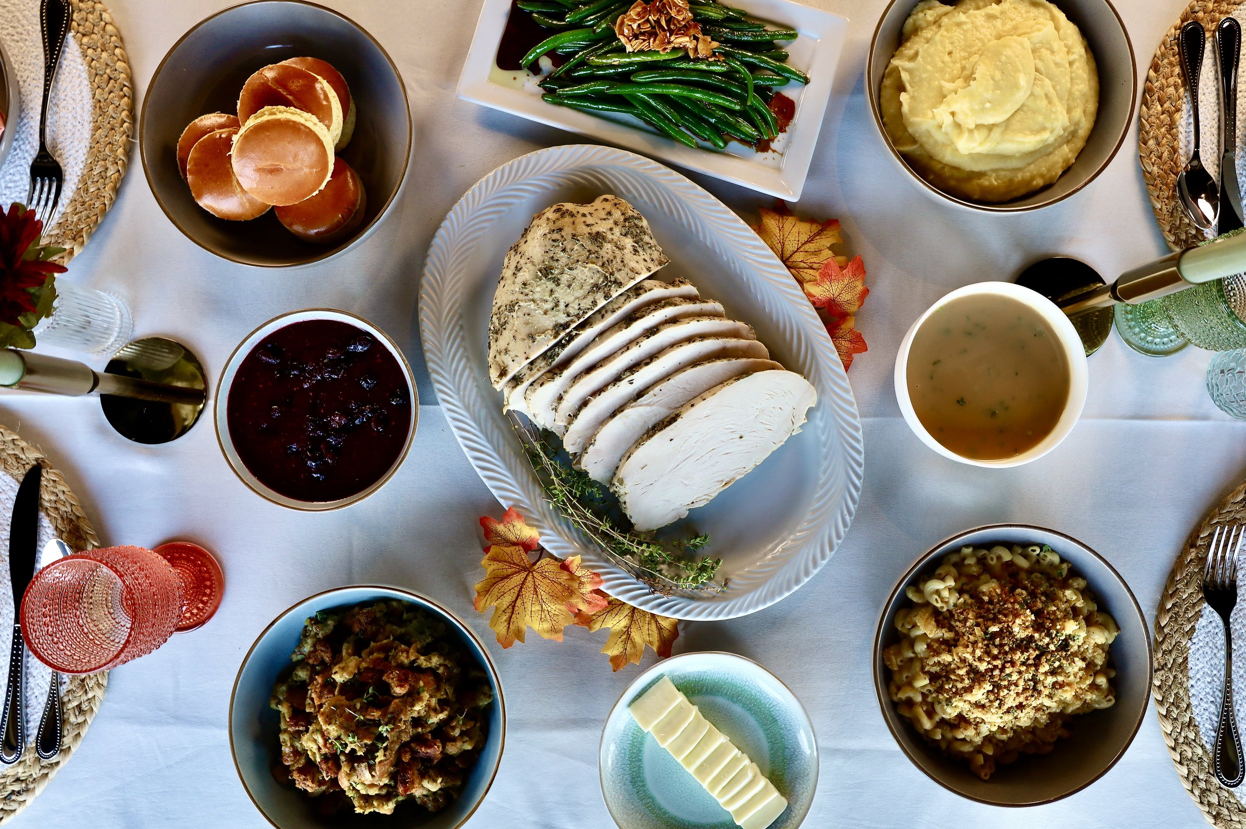 A tablescape of Thanksgiving Dinner with Mouthful Eatery catering beautifully displayed for the holiday.